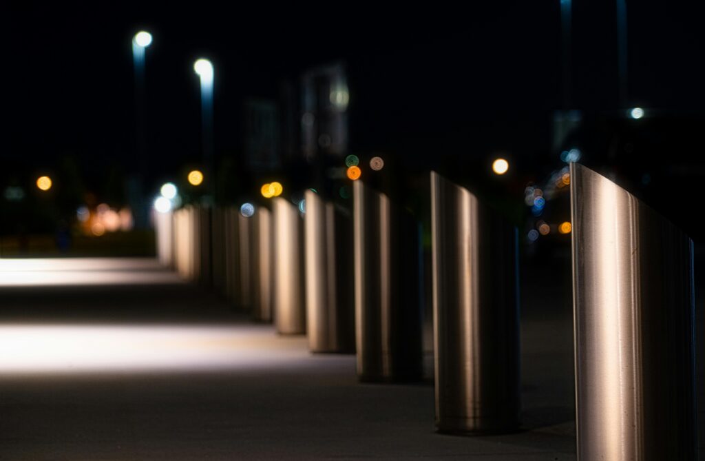 Explore the sleek design of illuminated urban bollards at night, showcasing modern architecture and ambient lighting.